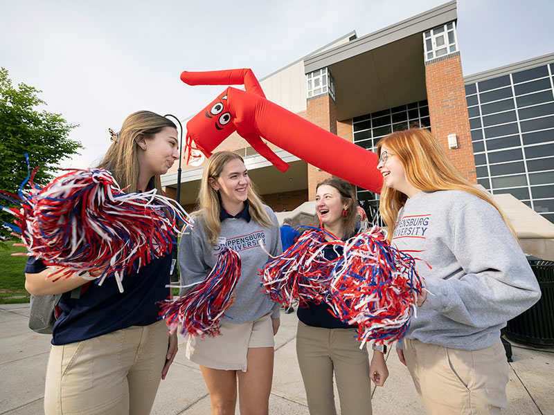 four Students with pompoms and Tube Men Blow Up Giant Waving Arm