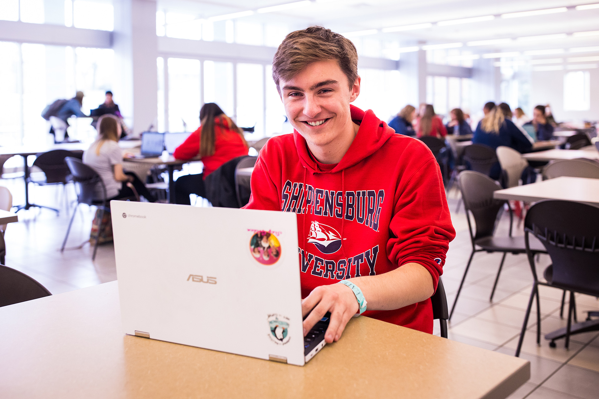 white male student working on his laptop in the CUB